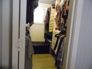 His & Her sides of walk-in closet with wardrobes